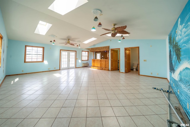 2268 E Knox St, Galesburg, IL 61401 - unfurnished living room featuring french doors, light tile patterned floors, baseboards, ceiling fan, and vaulted ceiling