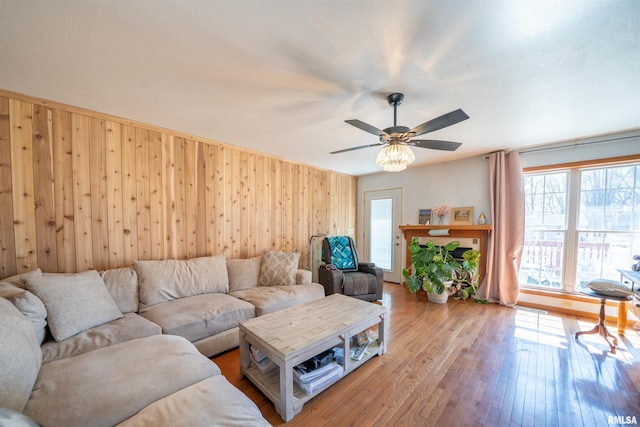 2268 E Knox St, Galesburg, IL 61401 - living area featuring wooden walls, ceiling fan, and wood-type flooring