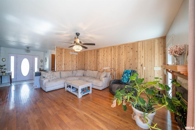 2268 E Knox St, Galesburg, IL 61401 - unfurnished living room with wood-type flooring, a ceiling fan, wood walls, and a fireplace