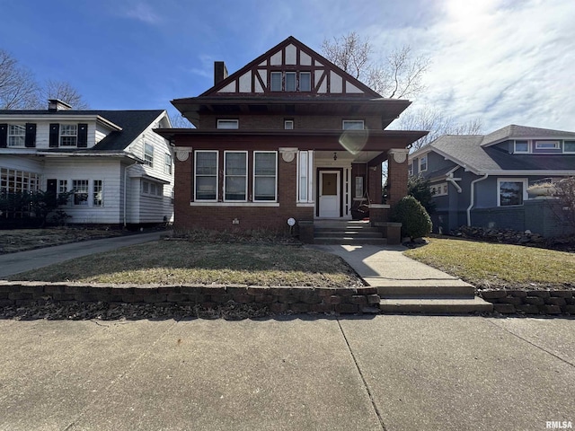 view of front facade with brick siding and a front yard