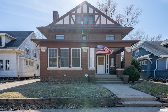 view of front of house featuring a front lawn, brick siding, and a chimney