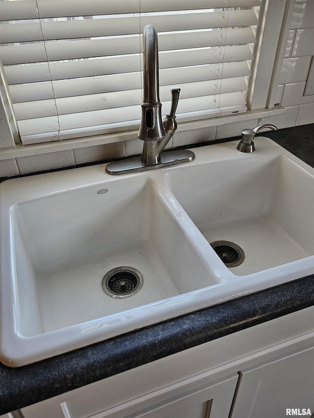 interior details with dark countertops and a sink