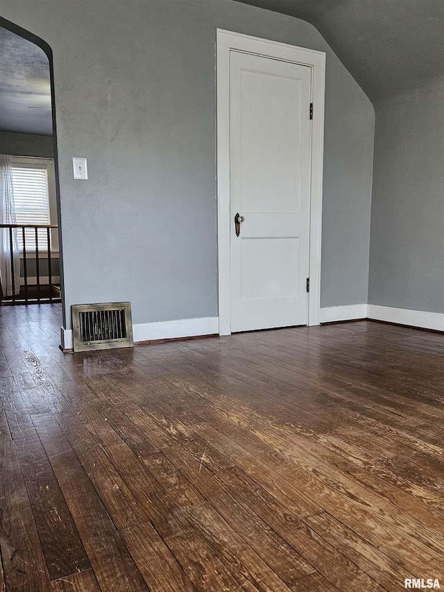 interior space featuring baseboards, visible vents, and wood-type flooring