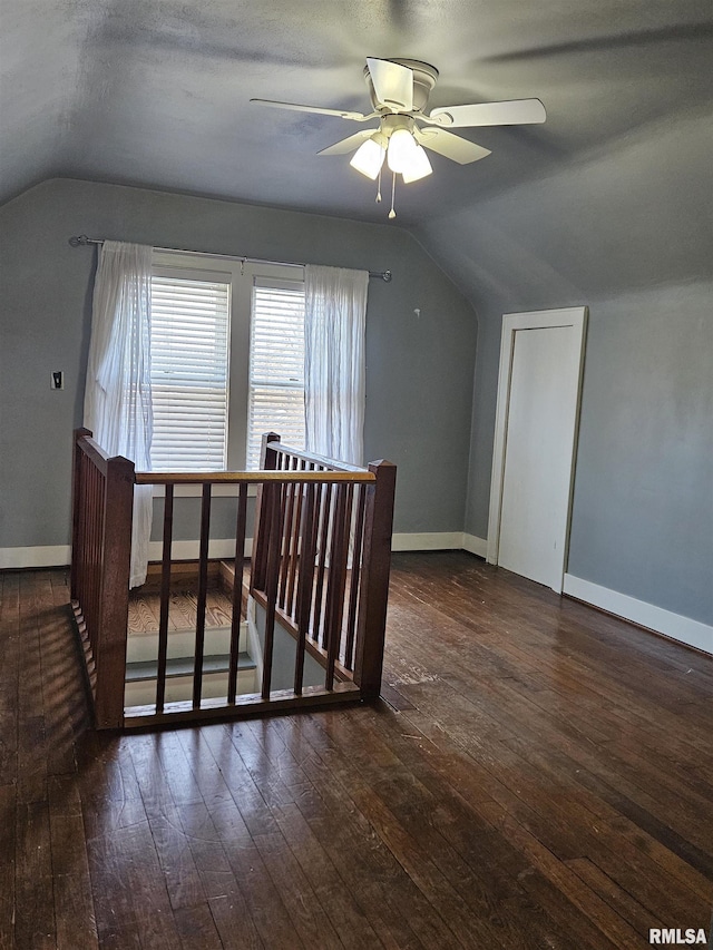 bonus room featuring baseboards, wood-type flooring, a ceiling fan, and vaulted ceiling