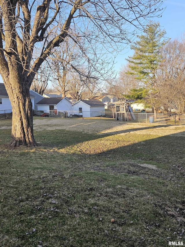 view of yard featuring fence and a playground