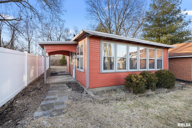 view of home's exterior featuring fence