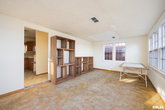 interior space with carpet flooring, baseboards, and visible vents