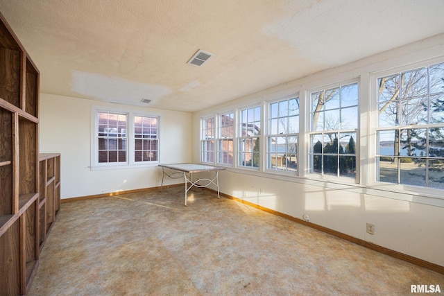 unfurnished sunroom featuring visible vents