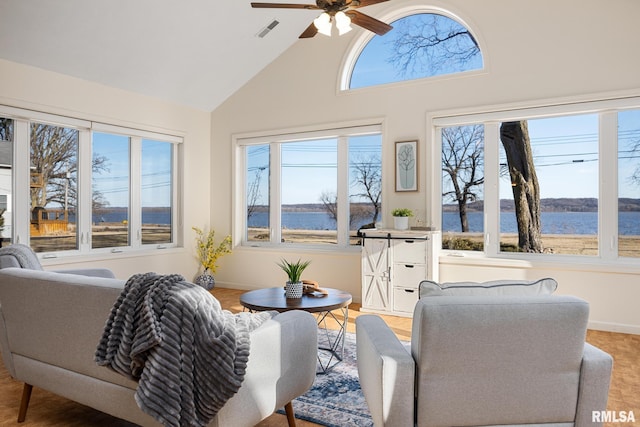 sunroom featuring visible vents, a ceiling fan, and lofted ceiling