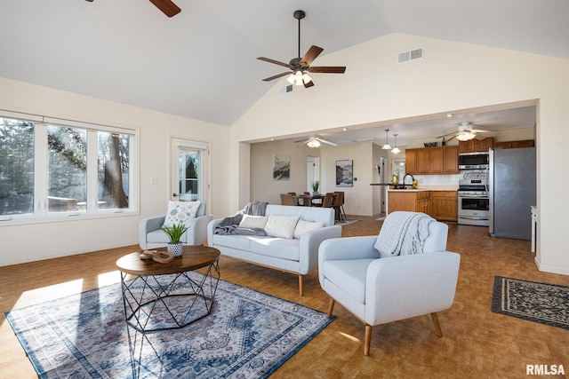 living area featuring ceiling fan, baseboards, visible vents, and high vaulted ceiling