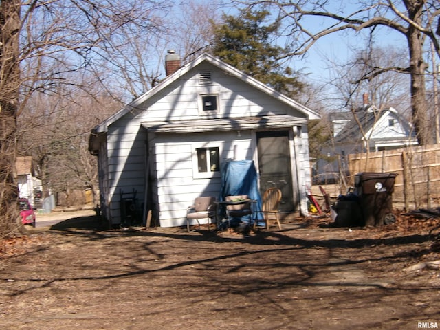 exterior space with fence and a chimney