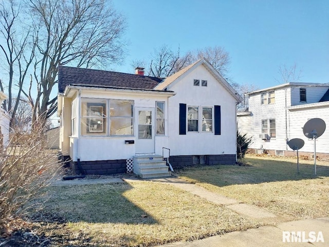 bungalow featuring a front lawn, entry steps, cooling unit, roof with shingles, and a chimney