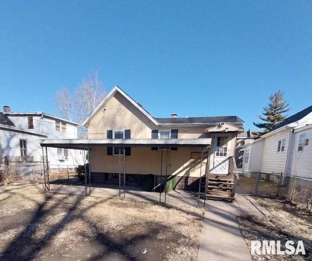 back of house featuring fence