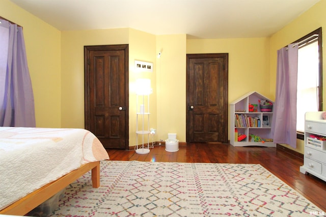 bedroom featuring visible vents and wood finished floors