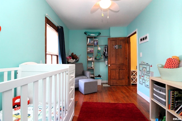 bedroom with baseboards, wood-type flooring, and ceiling fan