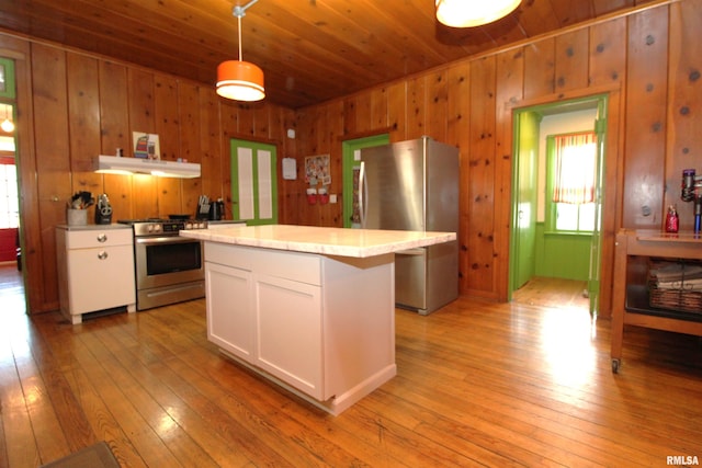 kitchen with light countertops, white cabinets, light wood finished floors, and appliances with stainless steel finishes