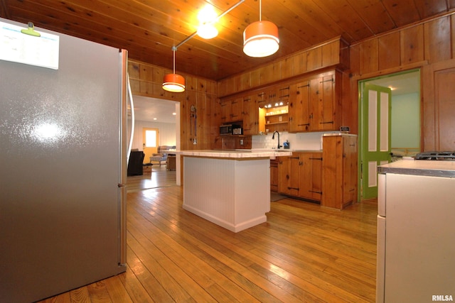 kitchen featuring a kitchen island, freestanding refrigerator, light countertops, wood ceiling, and light wood-type flooring