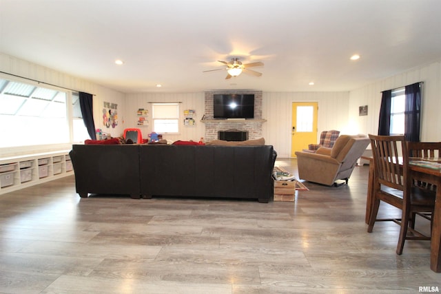 living area with plenty of natural light, a fireplace, and wood finished floors