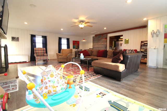 living area featuring visible vents, recessed lighting, a ceiling fan, and wood finished floors