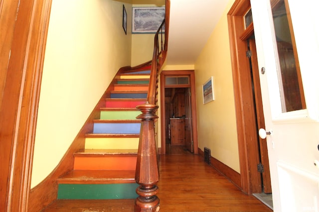 stairs featuring baseboards and wood finished floors