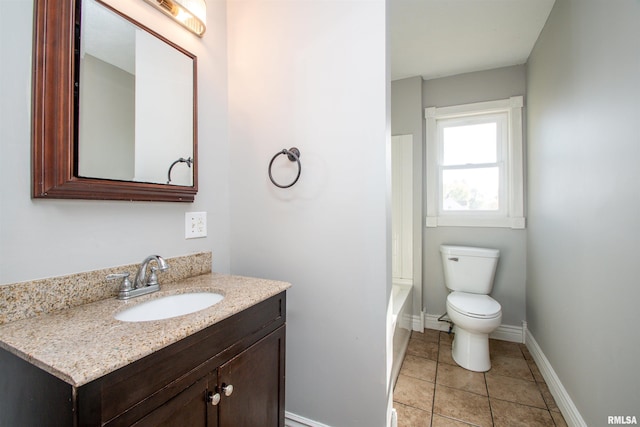 bathroom with tile patterned flooring, toilet, vanity, and baseboards