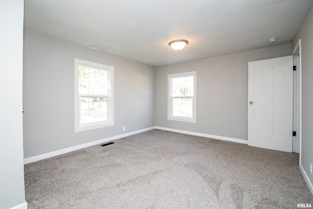 unfurnished room featuring visible vents, baseboards, and carpet flooring