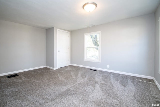 spare room featuring visible vents, baseboards, and carpet floors