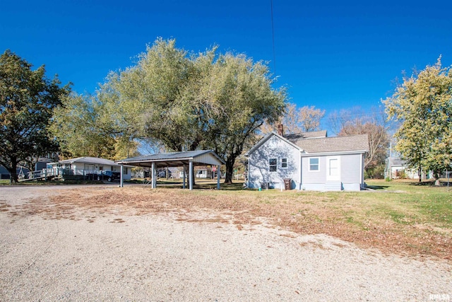 bungalow-style home featuring a carport and a front yard