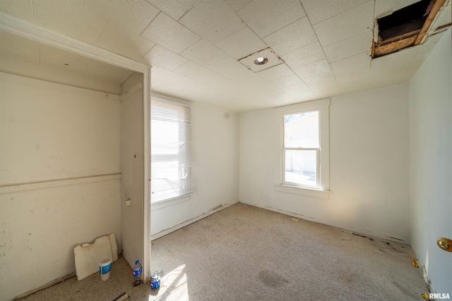 unfurnished bedroom with carpet flooring and multiple windows