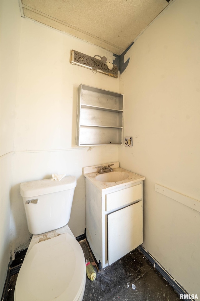 bathroom featuring toilet and vanity