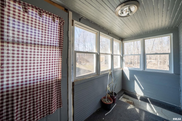 sunroom with a wealth of natural light and wood ceiling