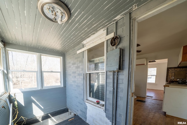 sunroom with visible vents, wooden ceiling, and an AC wall unit