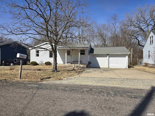 ranch-style home featuring covered porch, an attached garage, and driveway