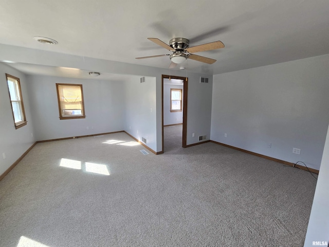 empty room featuring visible vents and a healthy amount of sunlight