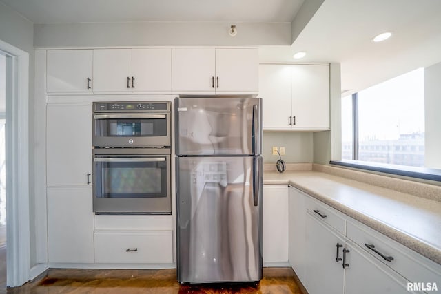 kitchen with light countertops, white cabinets, recessed lighting, and appliances with stainless steel finishes