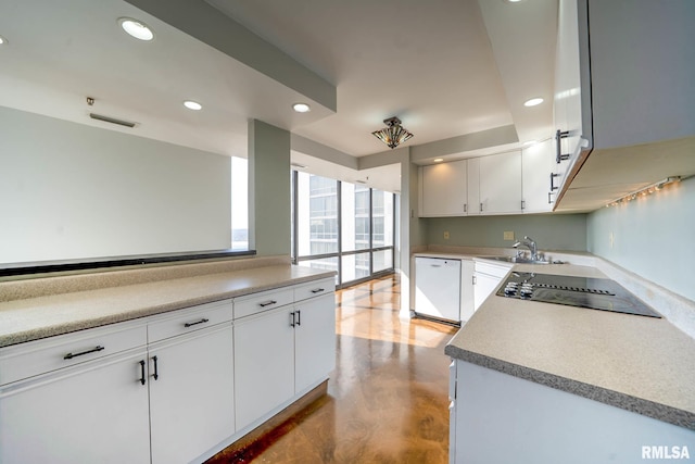 kitchen with recessed lighting, white dishwasher, a sink, white cabinets, and black electric stovetop