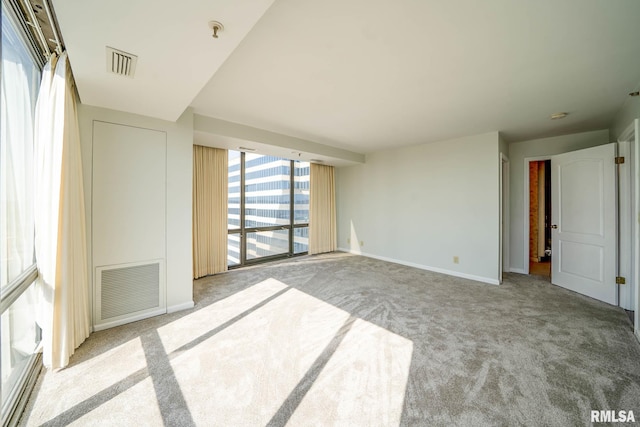 interior space featuring visible vents, baseboards, and carpet floors