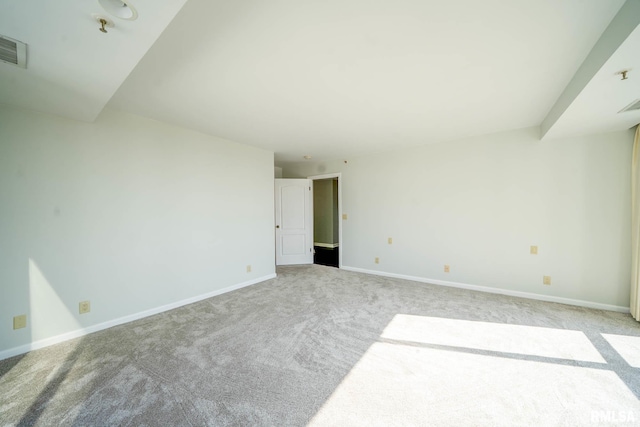 empty room with visible vents, carpet, and baseboards