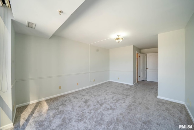 unfurnished room with carpet and baseboards