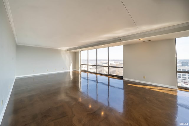 spare room featuring expansive windows, baseboards, concrete flooring, and crown molding