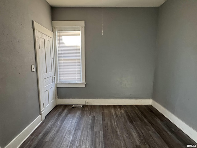929 W Brons Ave, Peoria, IL 61604 - spare room featuring dark wood-type flooring and baseboards