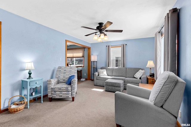 living area featuring carpet floors and ceiling fan