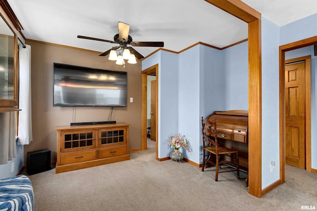 interior space featuring ceiling fan, baseboards, and ornamental molding