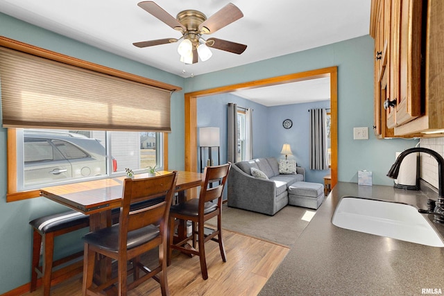 dining area featuring light wood finished floors and ceiling fan