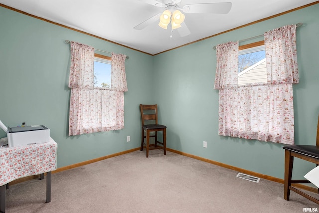 sitting room featuring visible vents, baseboards, ornamental molding, carpet floors, and a ceiling fan