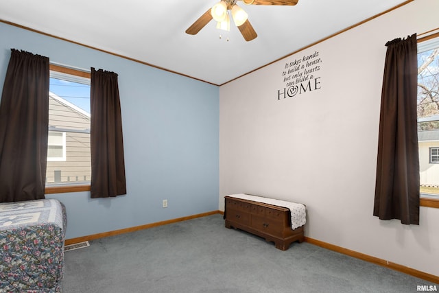 unfurnished bedroom featuring visible vents, multiple windows, baseboards, and carpet