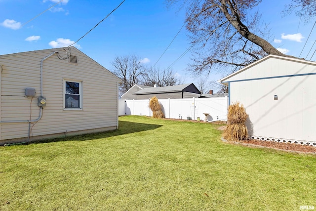 view of yard featuring an outdoor structure, a storage unit, and fence