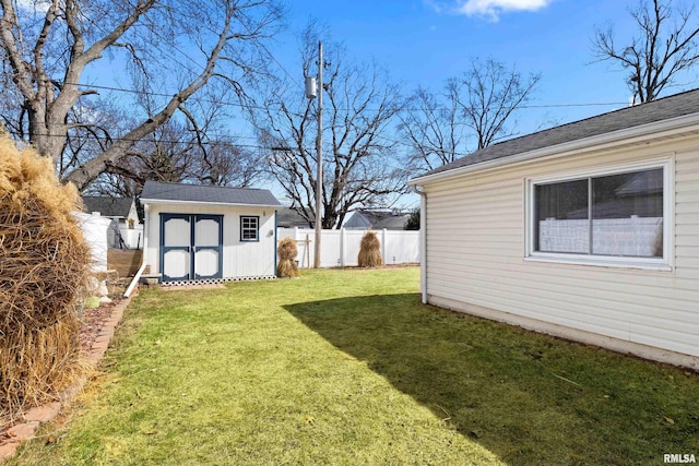 view of yard featuring an outbuilding, fence private yard, and a shed