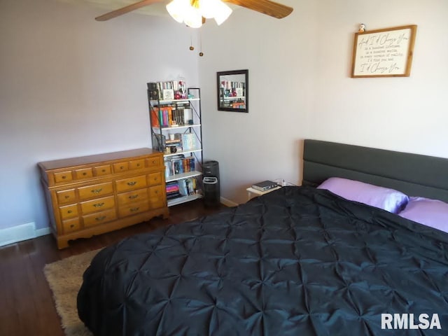 bedroom featuring baseboards, ceiling fan, and wood finished floors