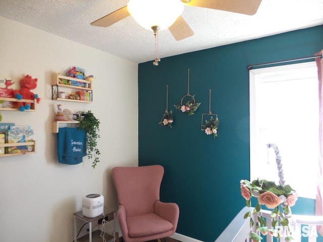 interior space featuring a textured ceiling and ceiling fan